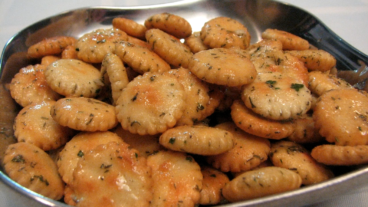 A Close-Up of Golden, Crispy Ranch Oyster Crackers Coated with Herbs and Seasoning in A Serving Bowl