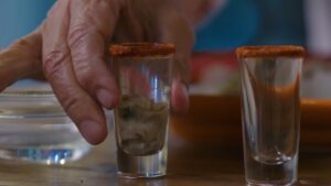 A Hand Reaches for A Spiced-Rim Oyster Shooter, Ready to Take a Sip